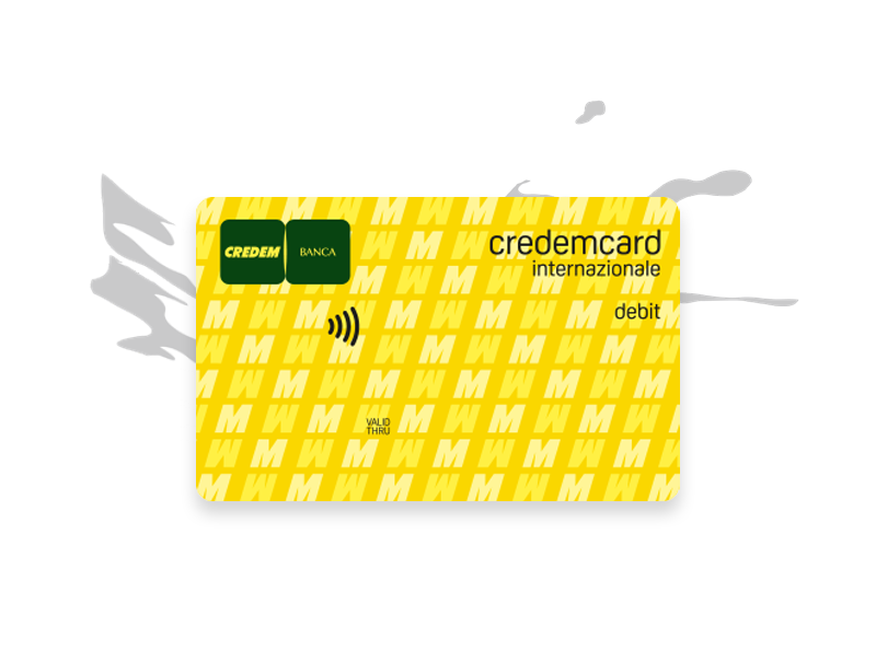 Carta di debito credemcard Internazionale di colore giallo e una grafica sequenziale con M maiuscole e M maiuscole rovesciate, logo della banca e icona contactless. “Credemcard internazionale debit”